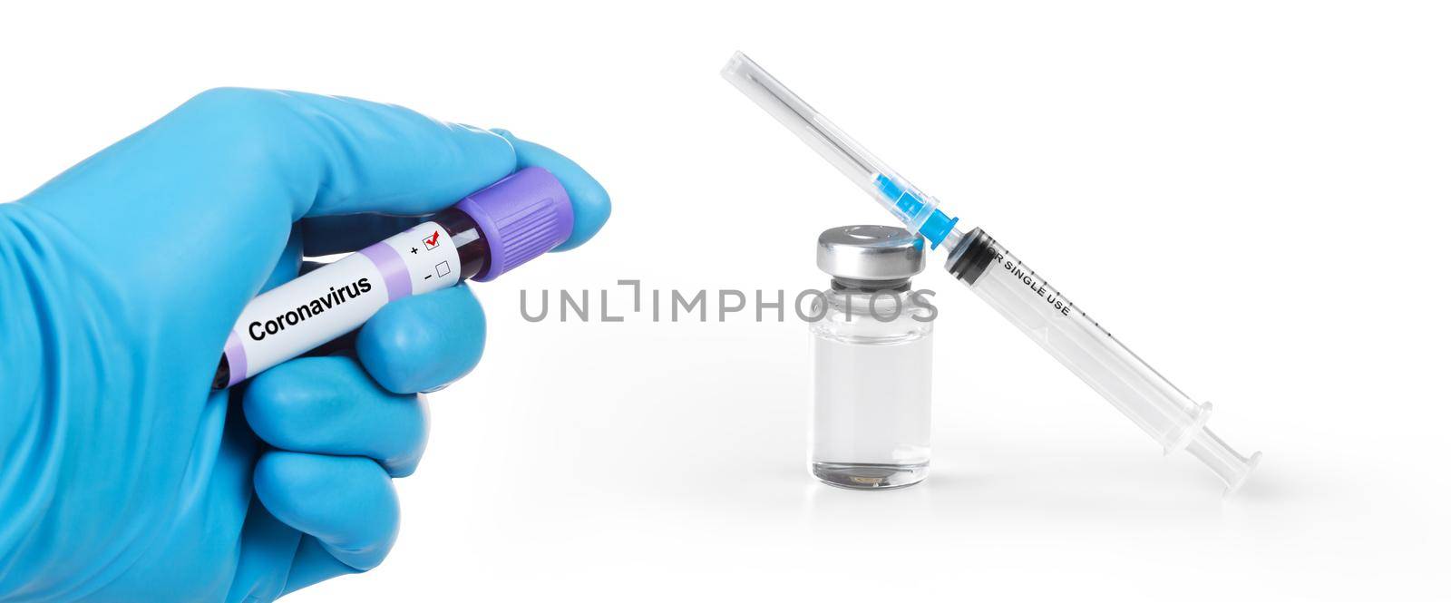 Hand holding viol with Coronavirus Blood Sample. Medical syringe and a bollte with vaccine. by Taut