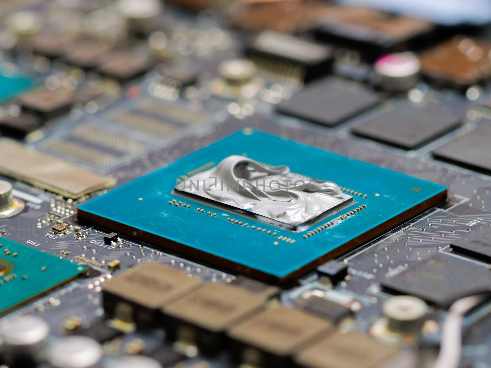 Graphics processor, GPU on the motherboard of a laptop with thermal paste. by RecCameraStock