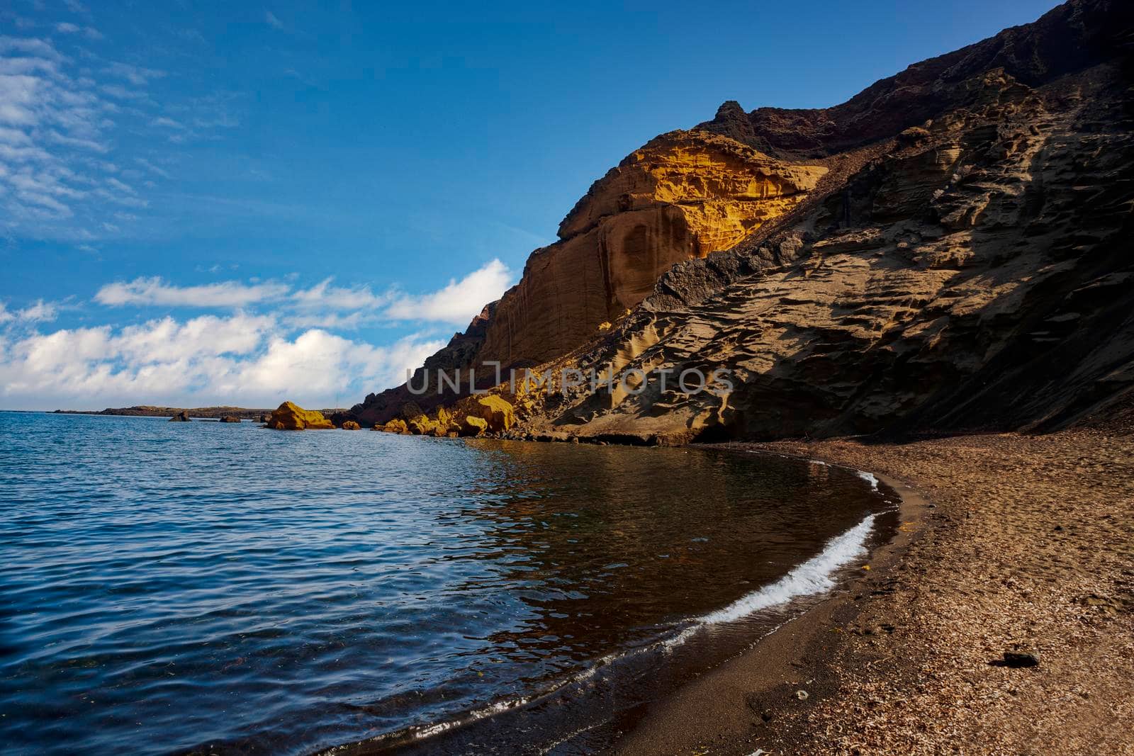 View of the Linosa volcano called Monte Nero in the beach of Cala Pozzolana di Ponente. Linosa is one of the Pelagie Islands in the Sicily Channel of the Mediterranean Sea