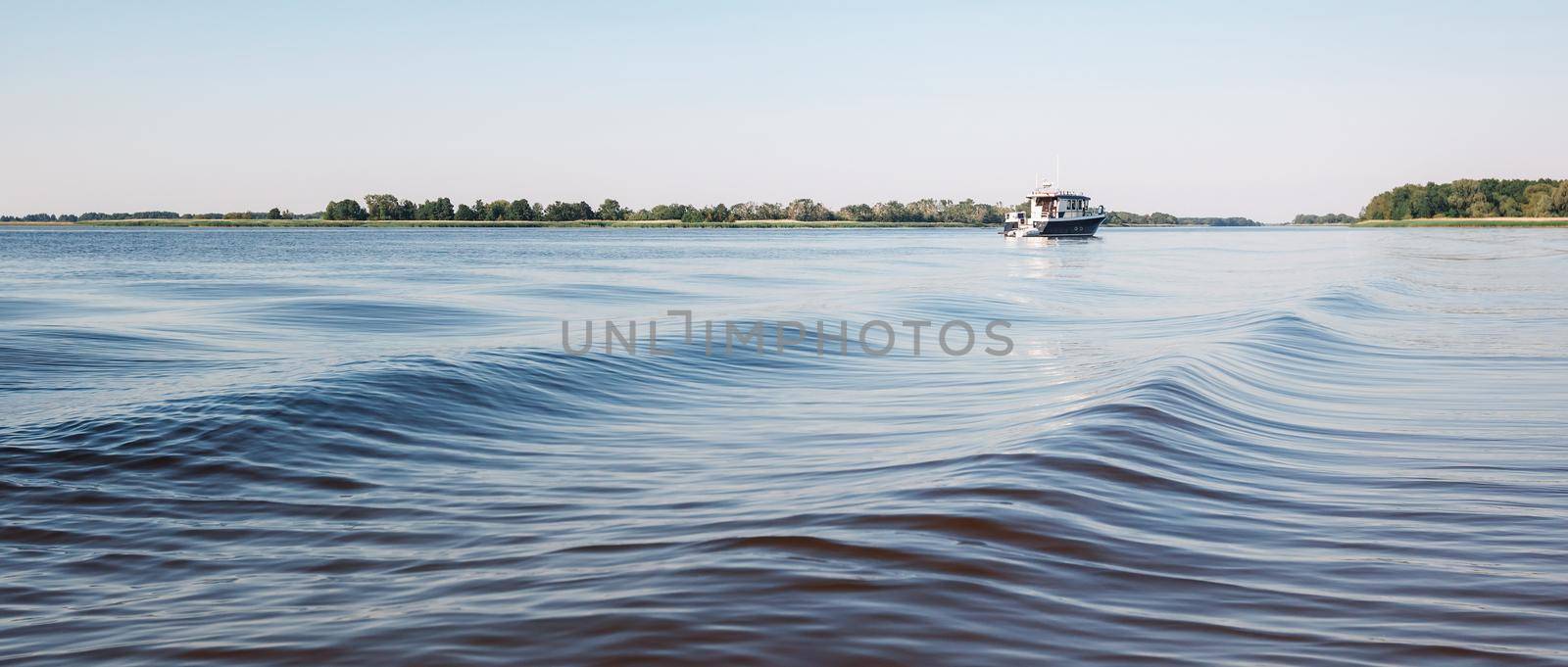 Amazing water waves and a small boat in the lagoon. by Lincikas