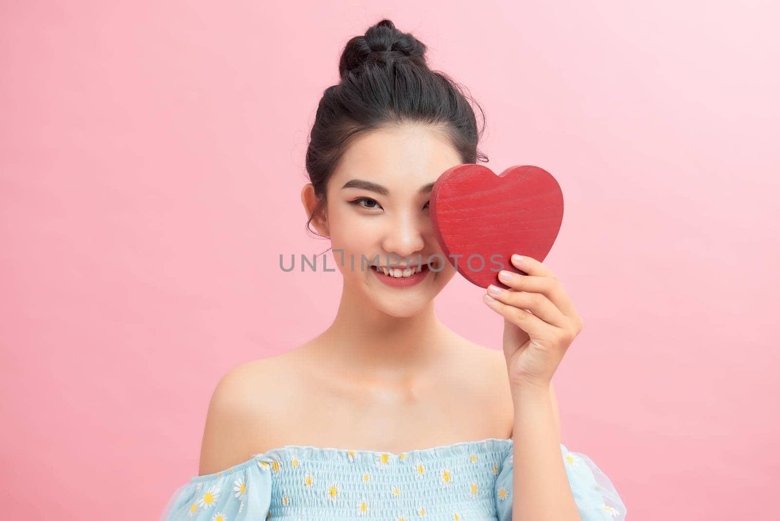 Woman holding paper heart shaped card . Valentine day concept . by makidotvn