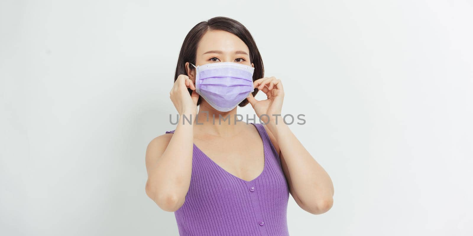Asian pregnant woman wear face mask holding her belly, look at camera, isolated on white  background, covid-19 concept