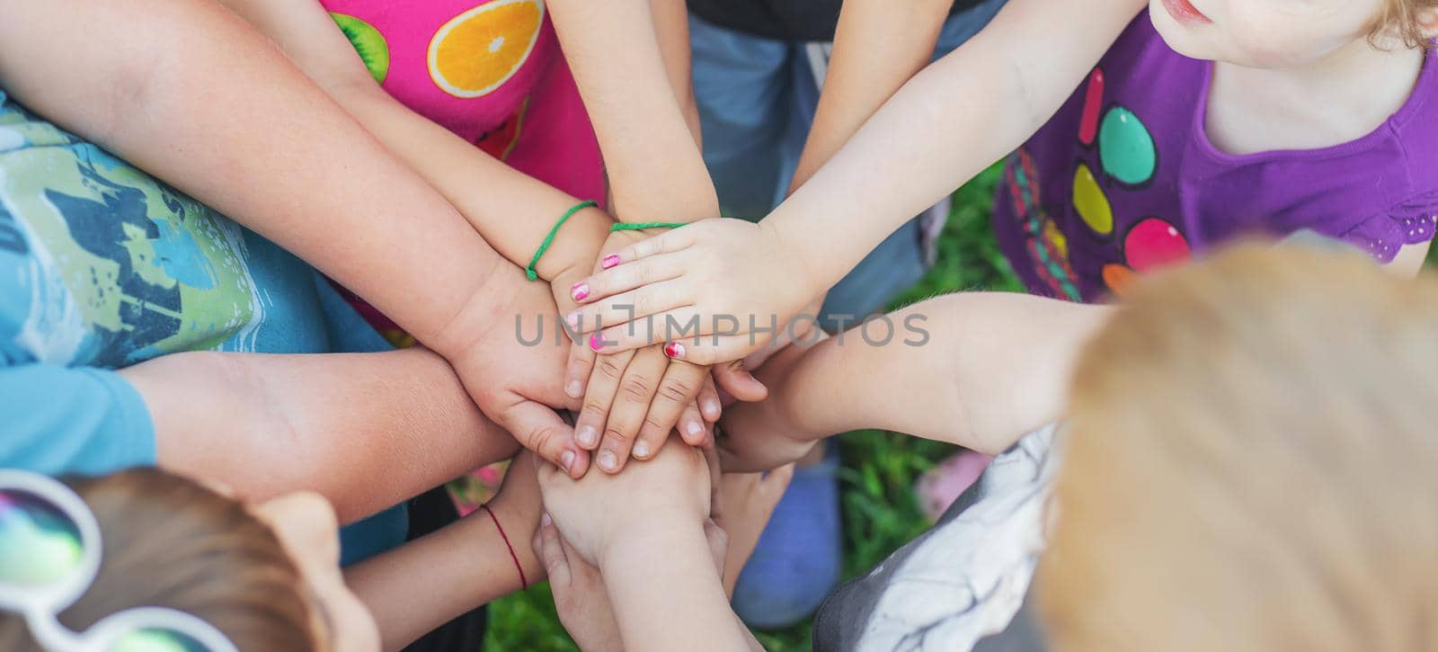 Children's hands together, street games. Selective focus. Kids.