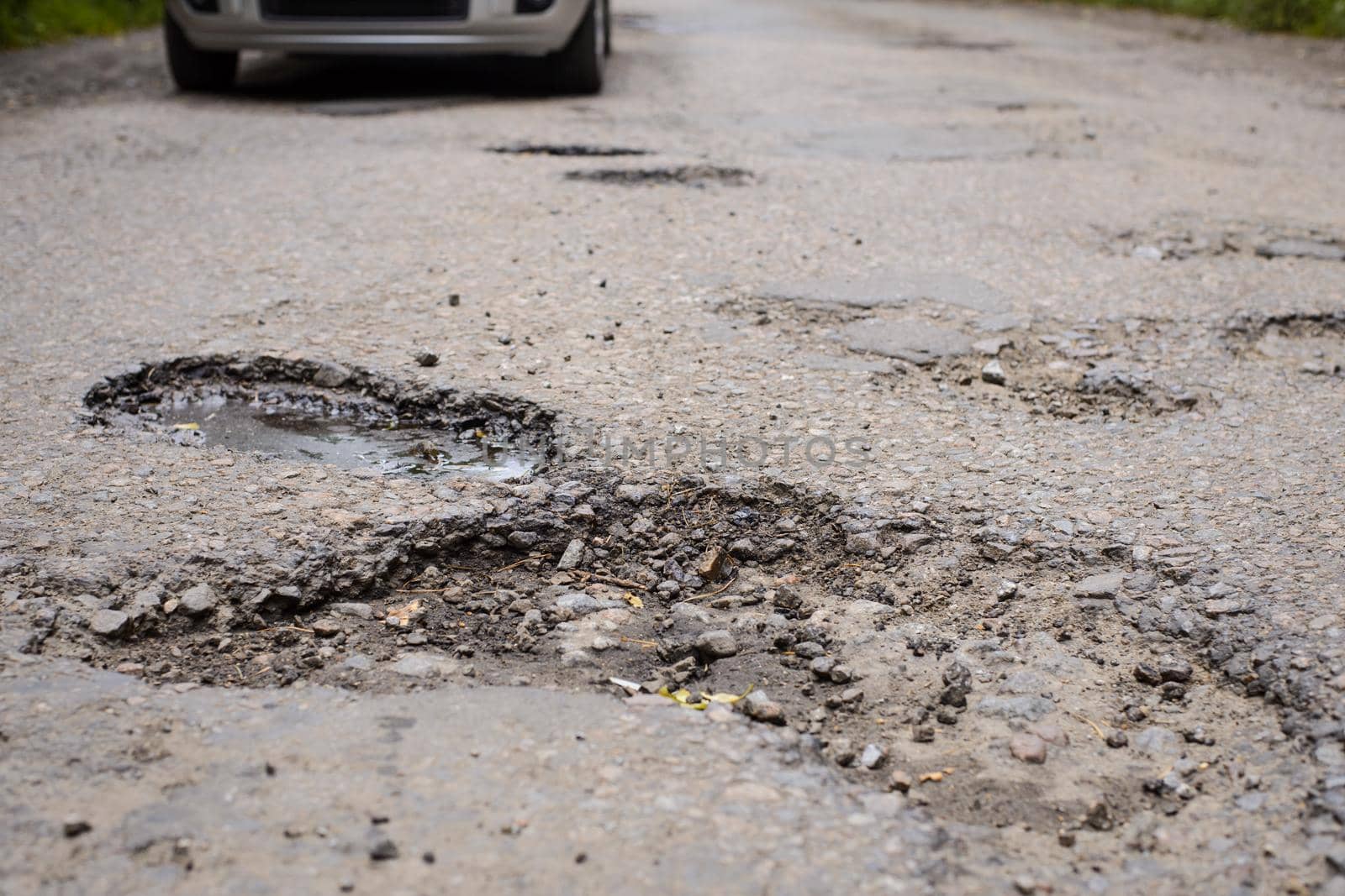 Many enormous potholes in asphalt surface by VitaliiPetrushenko