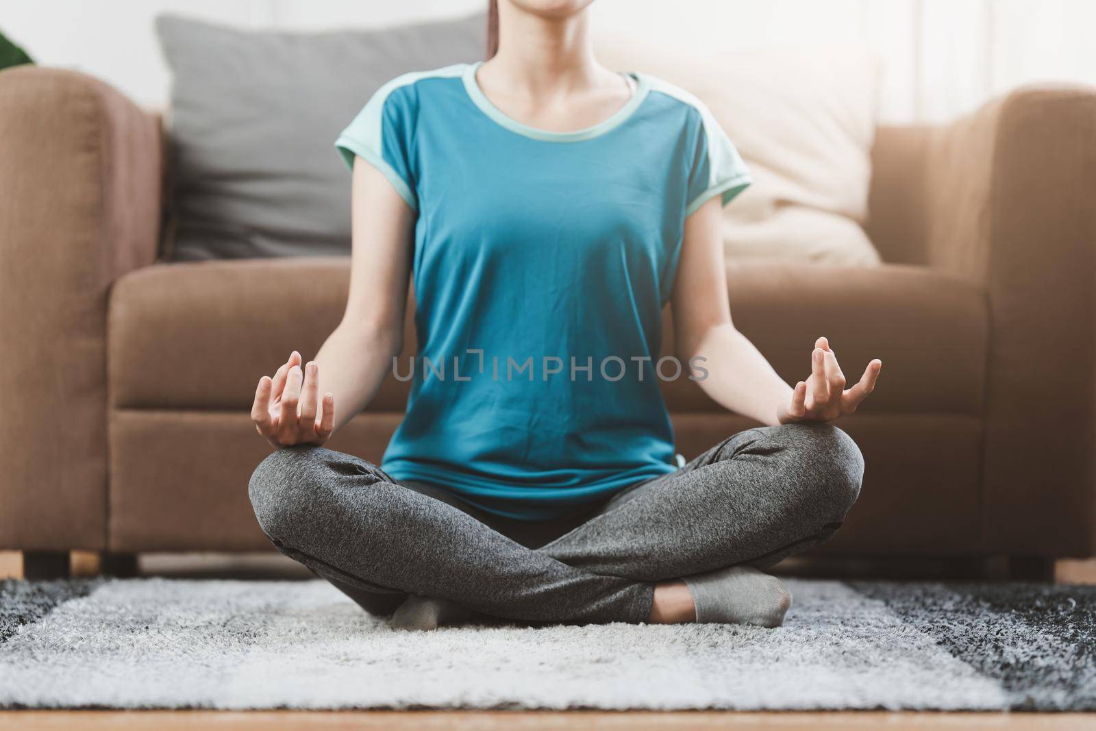 Young woman practicing yoga follow teacher in laptop online class at home. Calmness and relax concept