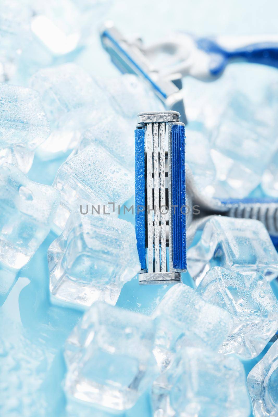 Refreshing shaving machine on the background of frosty ice cubes without irritation by AlexGrec