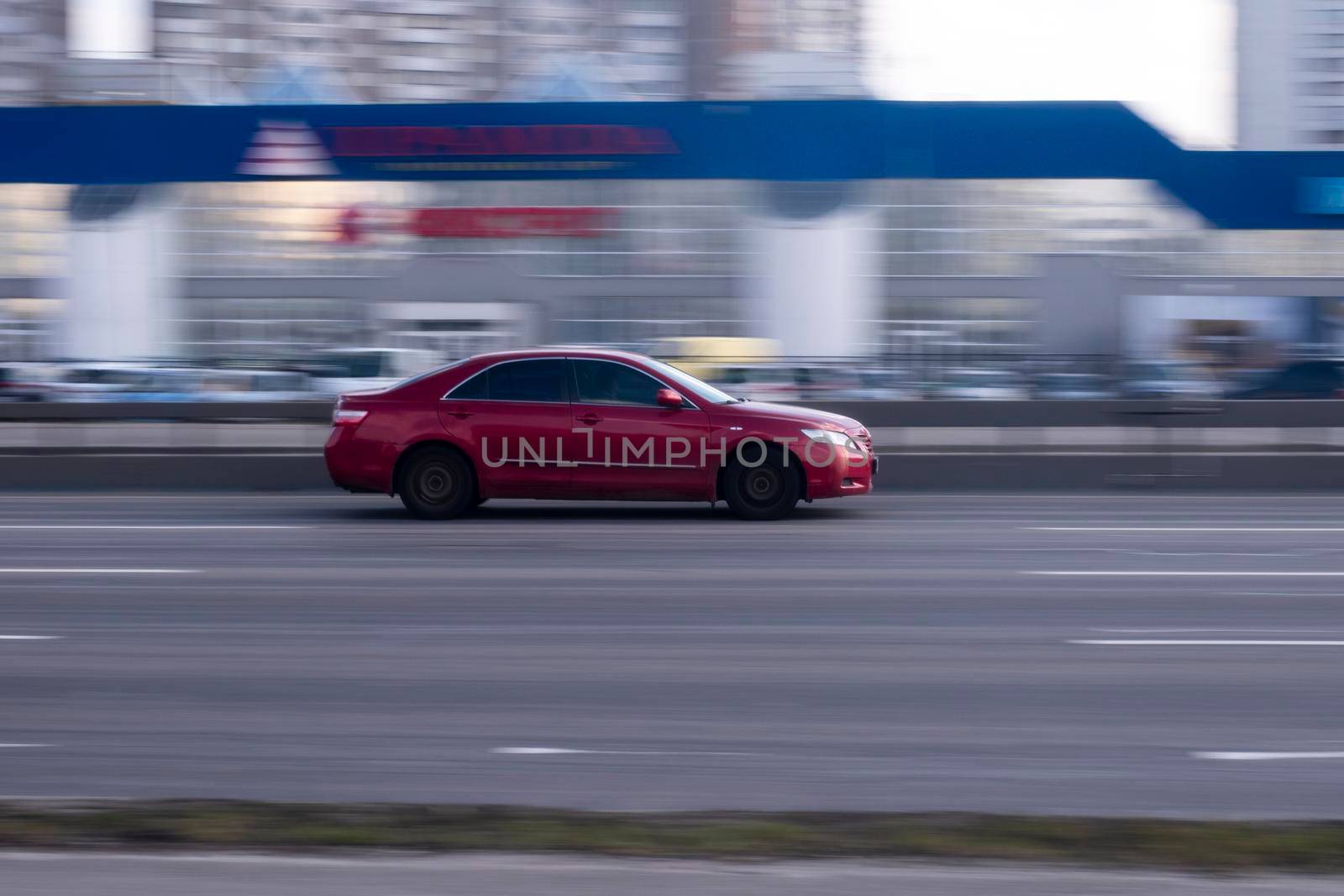 Ukraine, Kyiv - 21 March 2021: Red Toyota Camry car moving on the street. Editorial