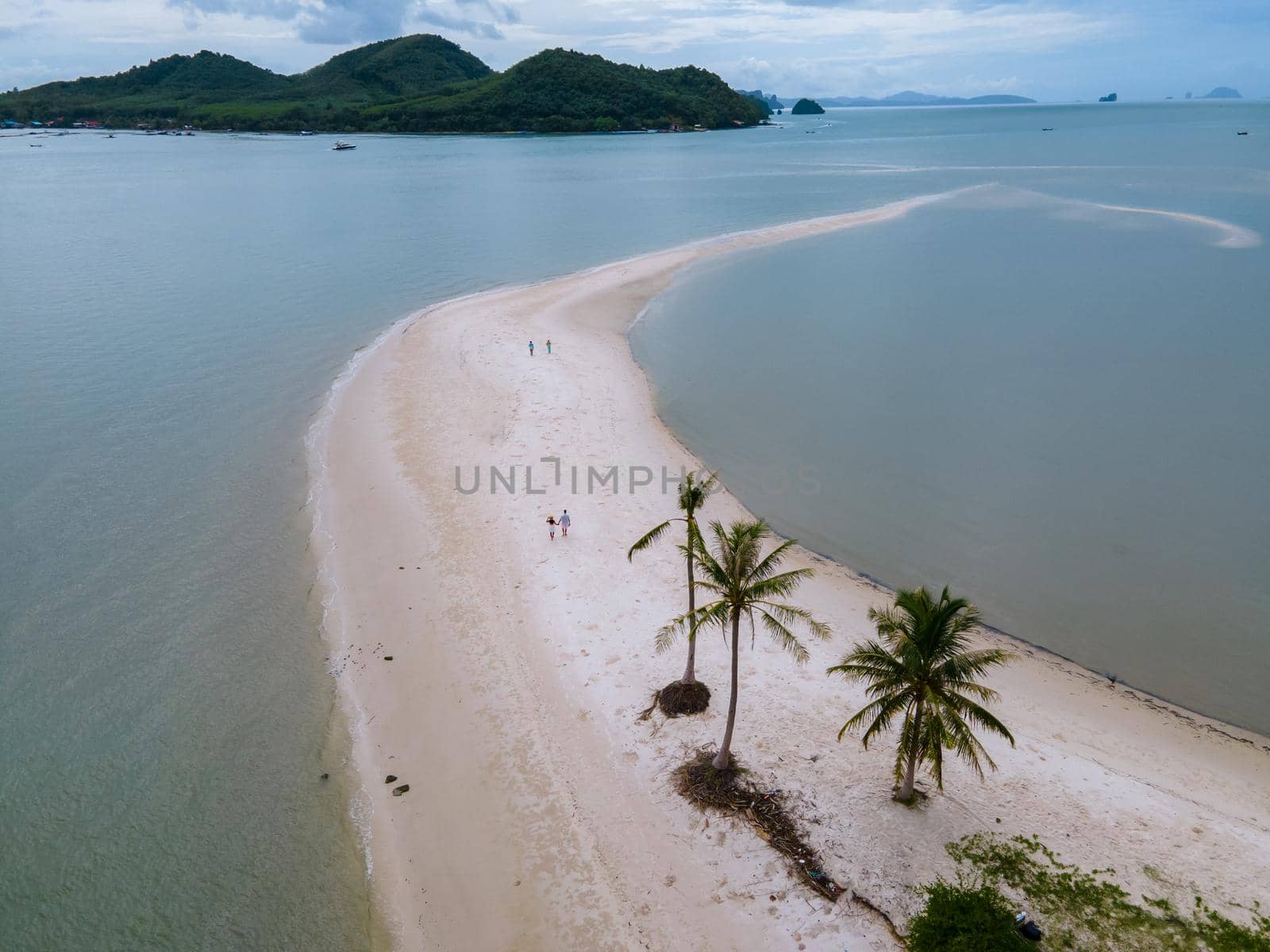 couple men and women walking on the beach at the Island Koh Yao Yai thailand, beach with white sand and palm trees by fokkebok