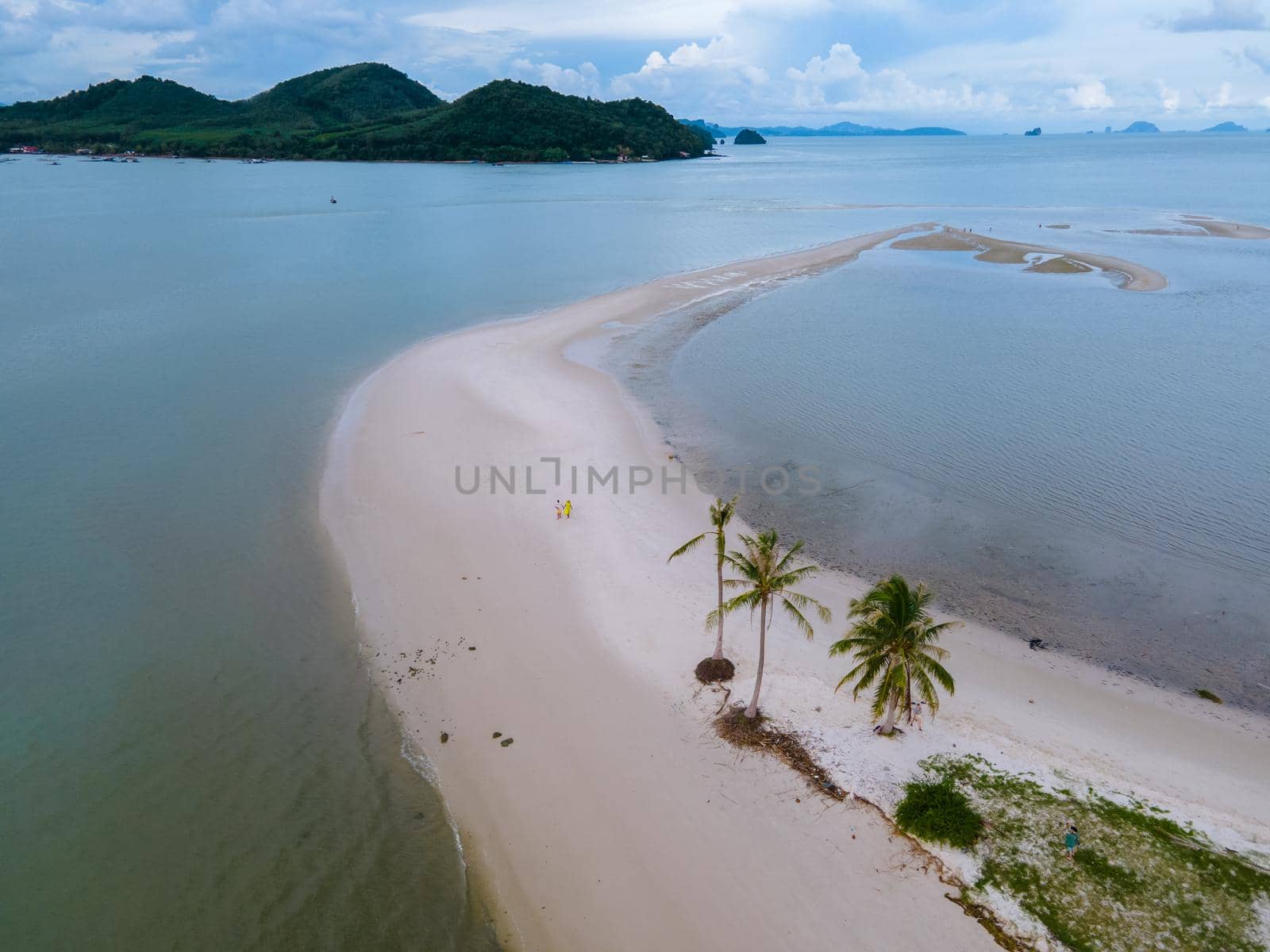 couple men and women walking on the beach at the Island Koh Yao Yai thailand, beach with white sand and palm trees by fokkebok