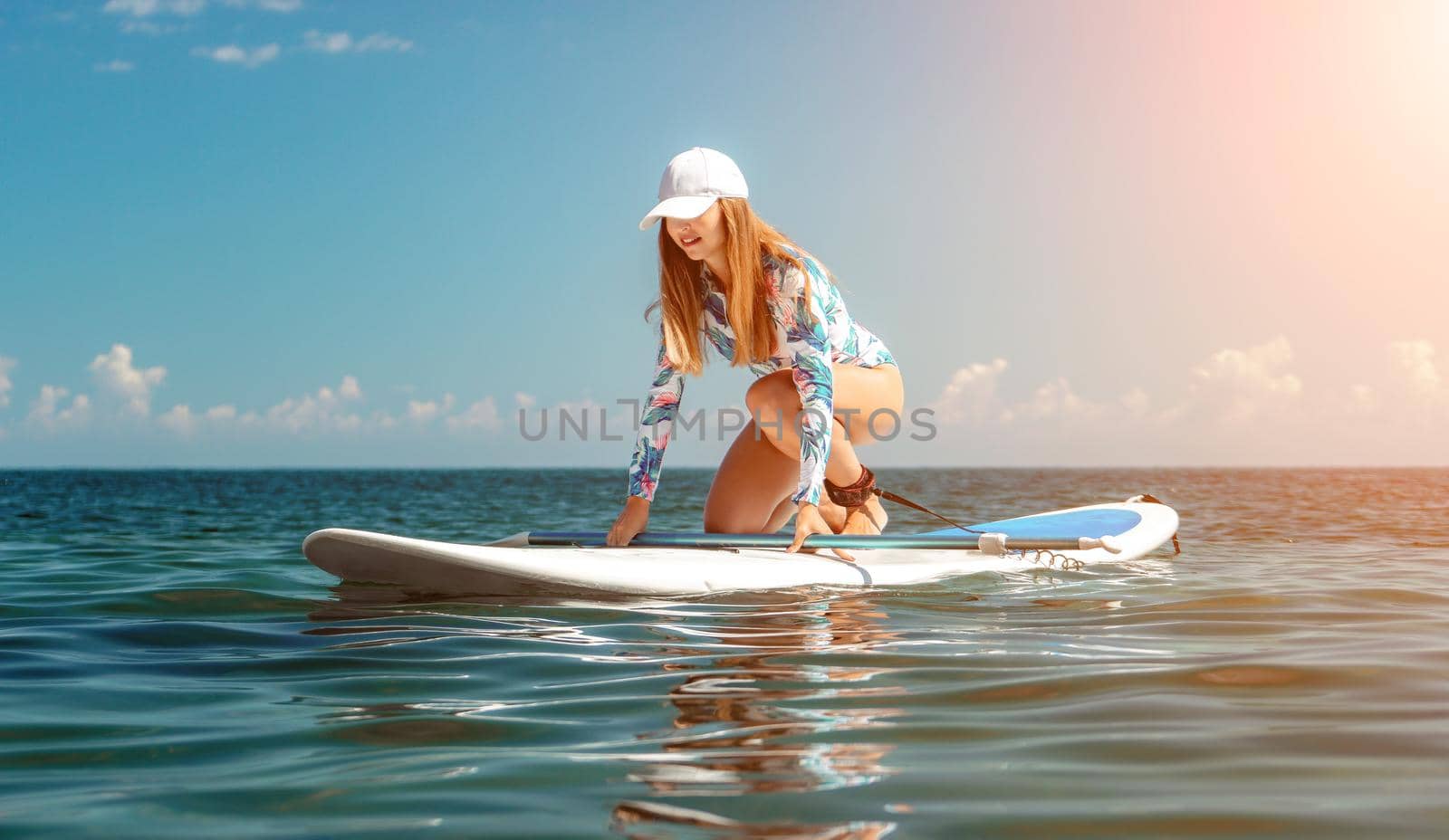 SUP Stand up paddle board. Young woman sailing on beautiful calm sea with crystal clear water. The concept of an summer holidays vacation travel, relax, active and healthy life in harmony with nature