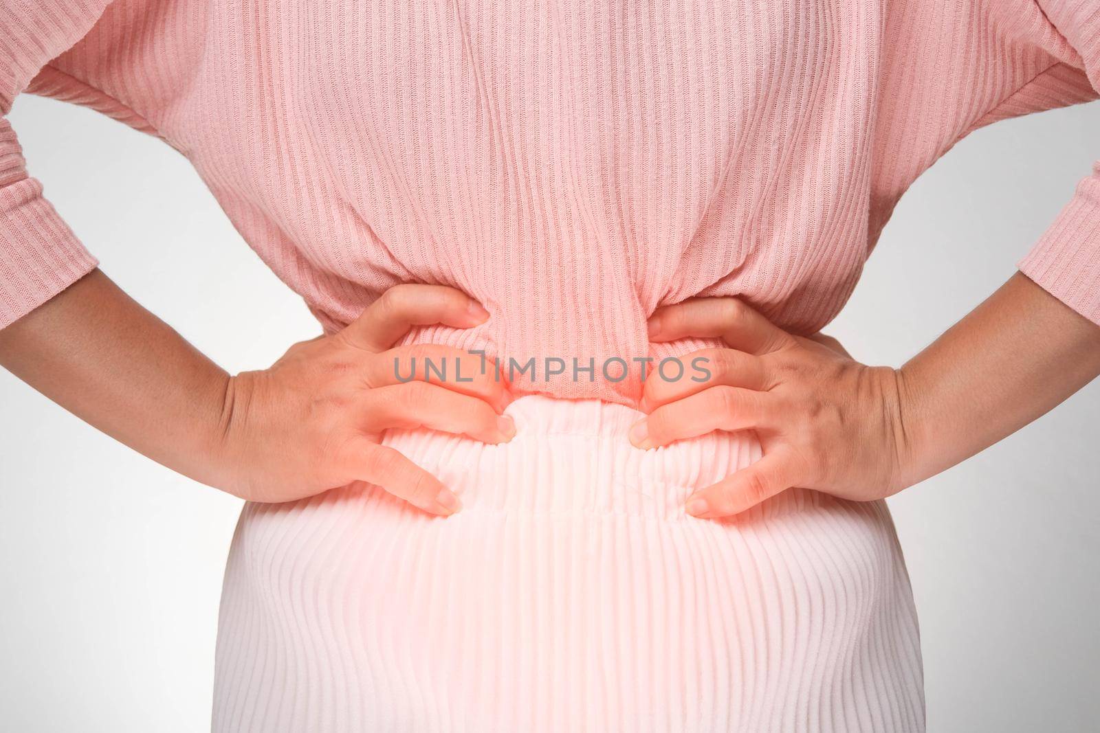 Woman holding hands on stomach with menstrual pain, abdominal pain, stomach ache, food poisoning on white background. close up. Health problems by TEERASAK