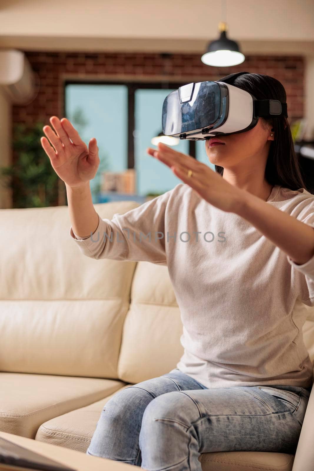 Happy asian woman enjoying wearing VR virtual reality headset, modern glasses technology headset future device gadget digital entertainment game simulation