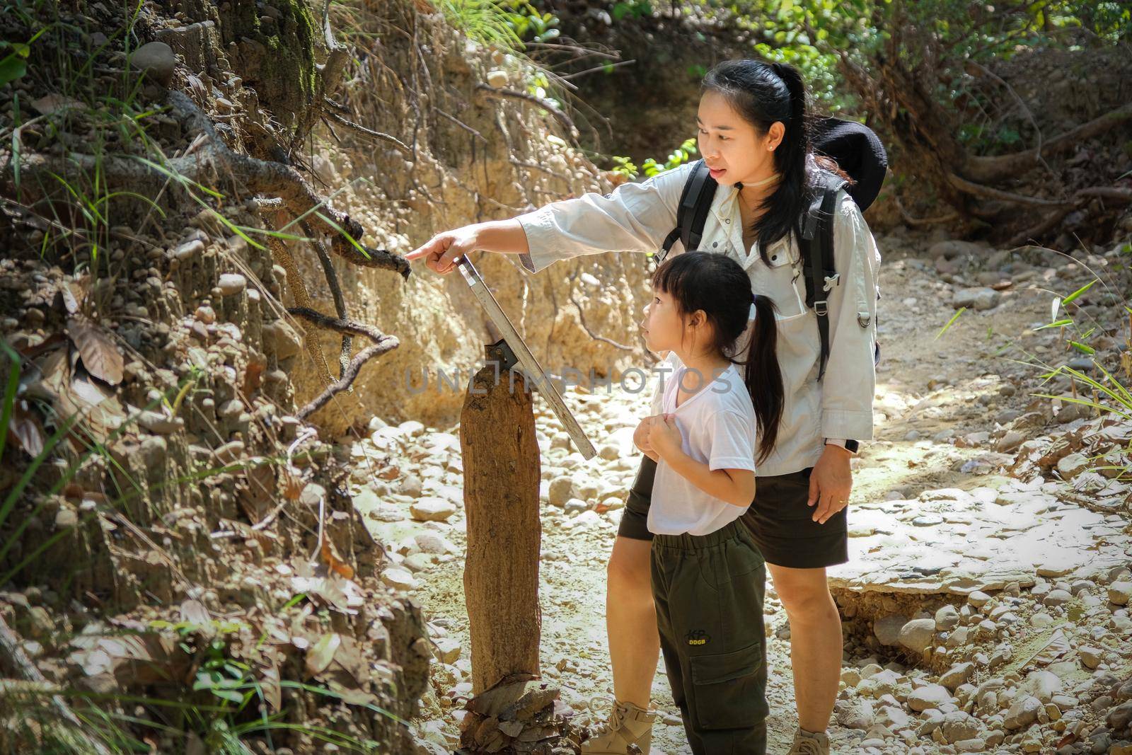 Asian tourist family, mother and daughter travel to the Pha Cho is high soil canyon cliffs at Mae Wang National parks in Chiang Mai,Thailand. Travel and lifestyle concepts by TEERASAK