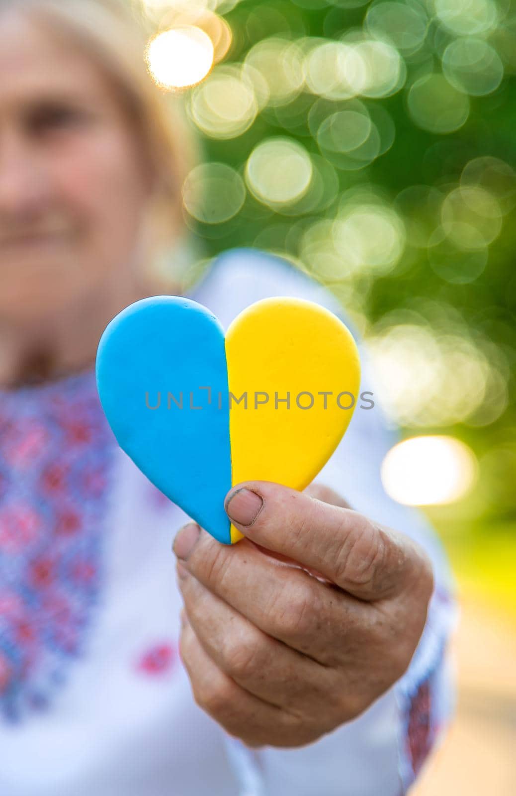 Grandmother in Ukrainian embroidered clothes. Selective focus. by yanadjana