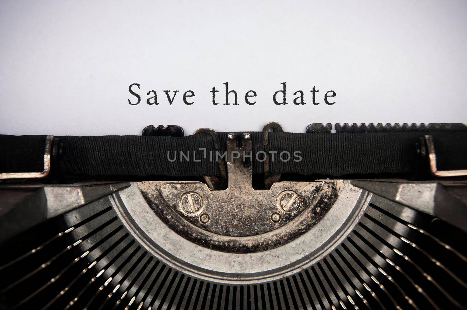Save the date text typed on an old vintage typewriter. Conceptual