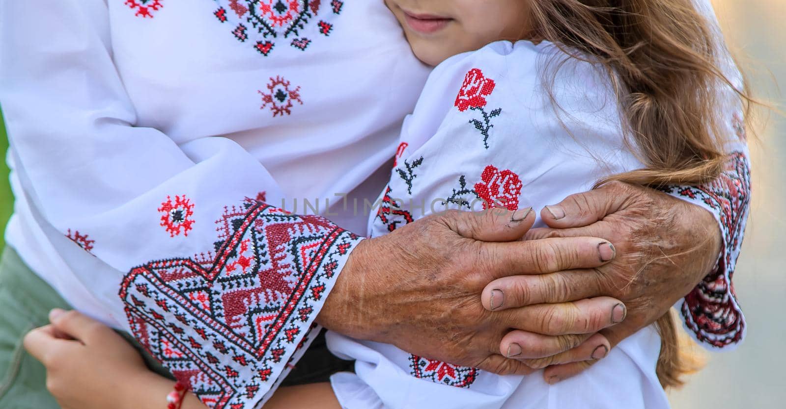 Ukrainian grandmother and granddaughter in vyshyvanka. selective focus. Kid.