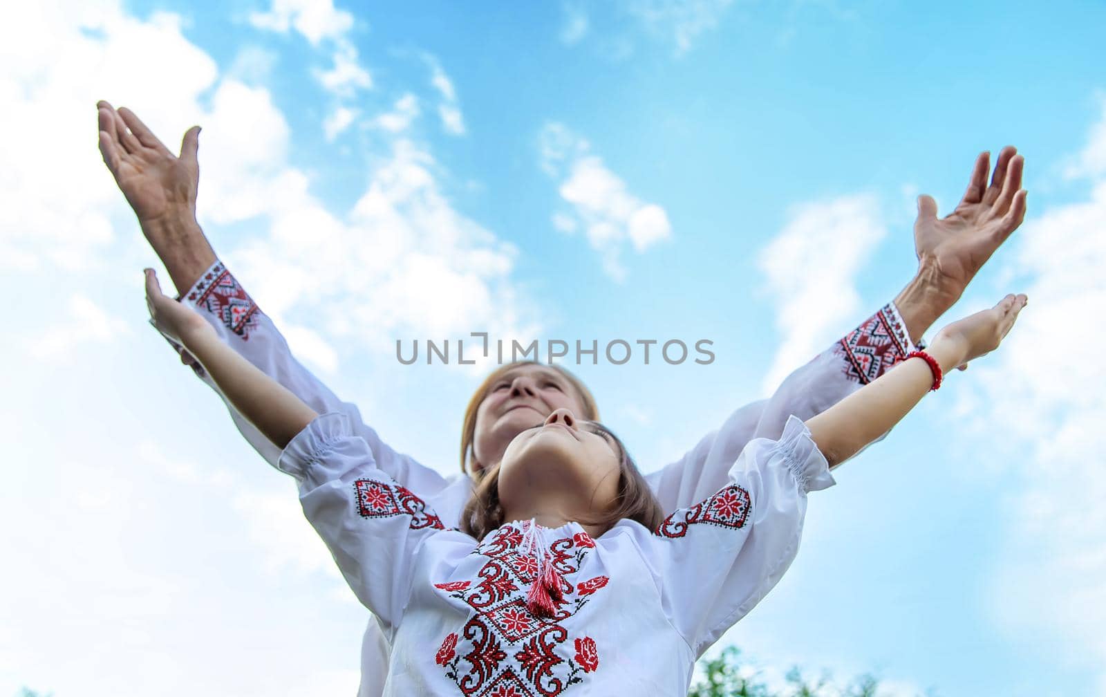 Ukrainian grandmother and granddaughter in vyshyvanka. selective focus. Kid.