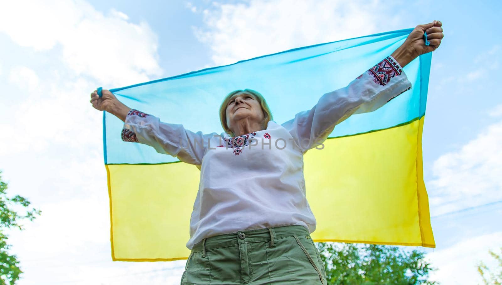 Grandmother in Ukrainian embroidered clothes. Selective focus. Nature.