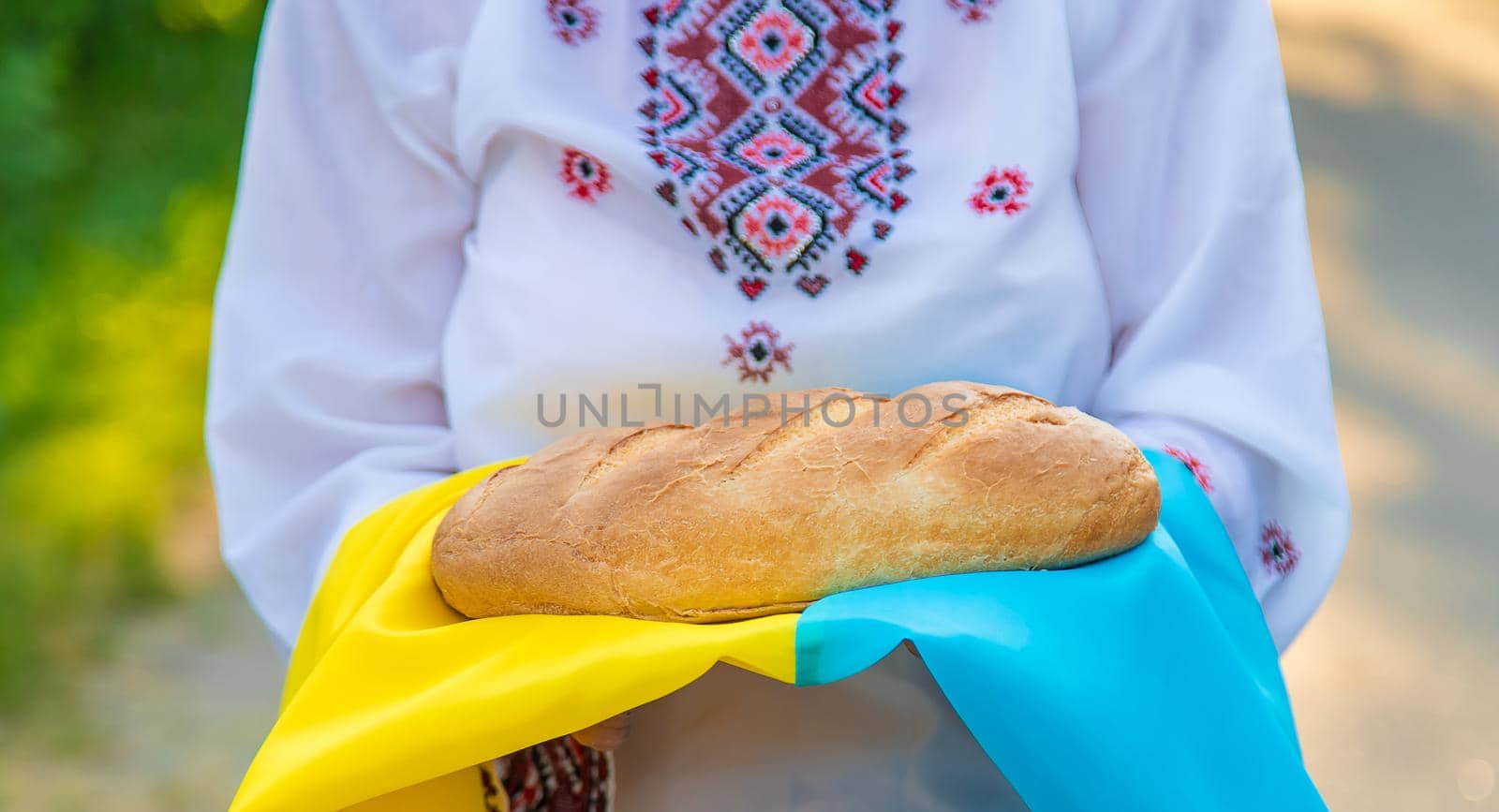 Grandmother with Ukrainian bread in her hands. Selective focus. Food.