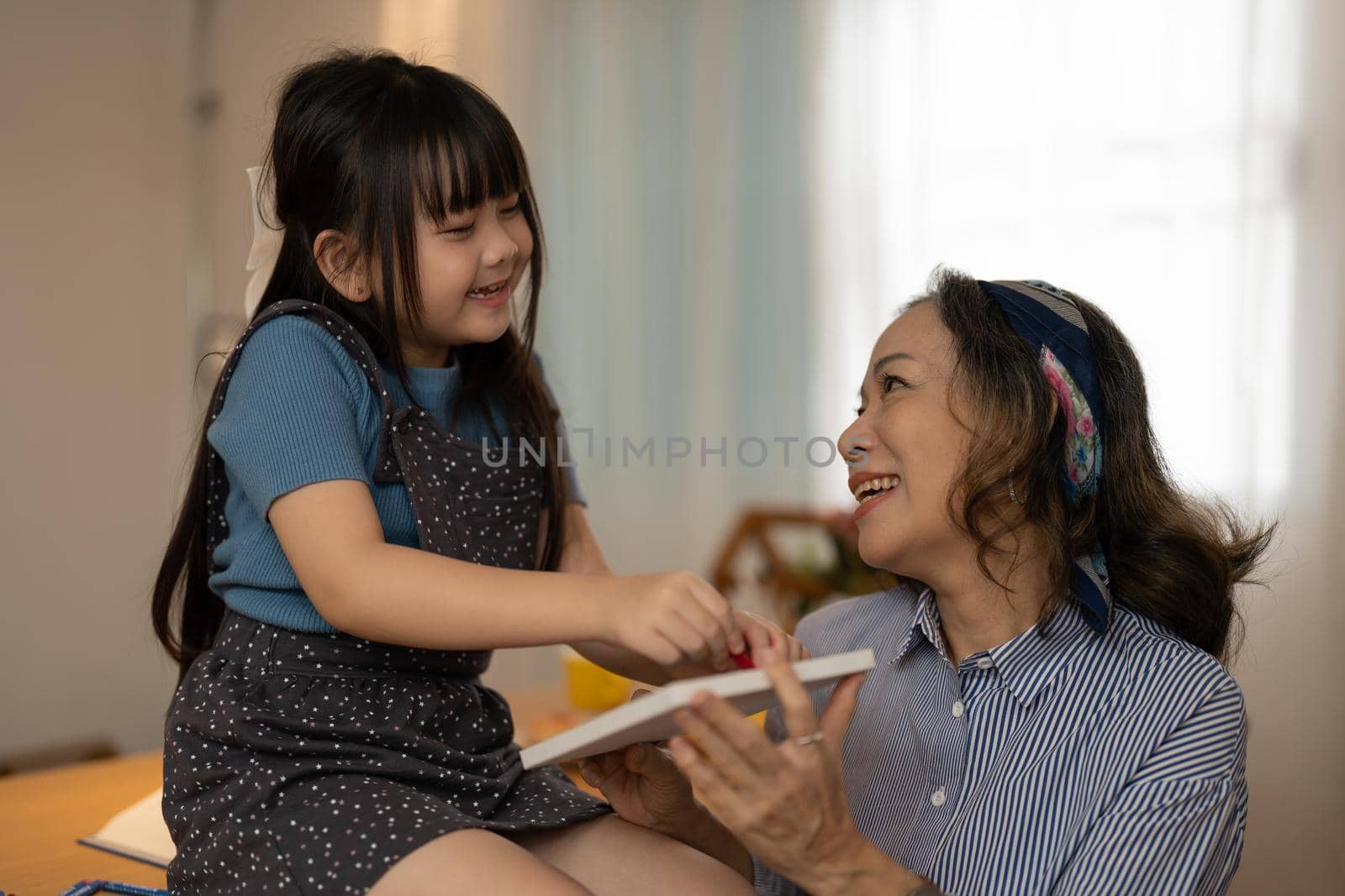 Asian portrait, grandchild granddaughter grandma grandmother and granddaughter happily join in activities to enhance skills for grandchildren.