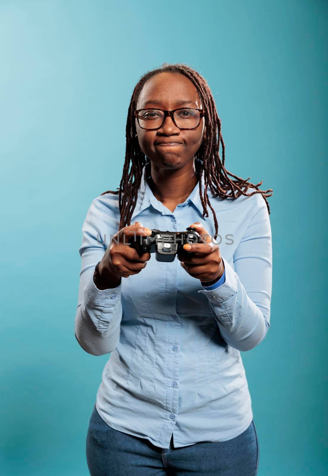 Portrait of young adult person enjoying leisure time by playing videogames on console device with modern gaming controller. Unpleased woman dissapointed because of lost game match.