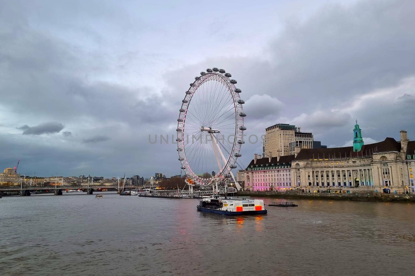 London, United Kingdom, February 7, 2022: Scenic view of the River Thames in London. The London Eye is a Ferris wheel in London, located in the Lambeth district on the south bank of the Thames. The largest in Europe and one of the largest in the world.