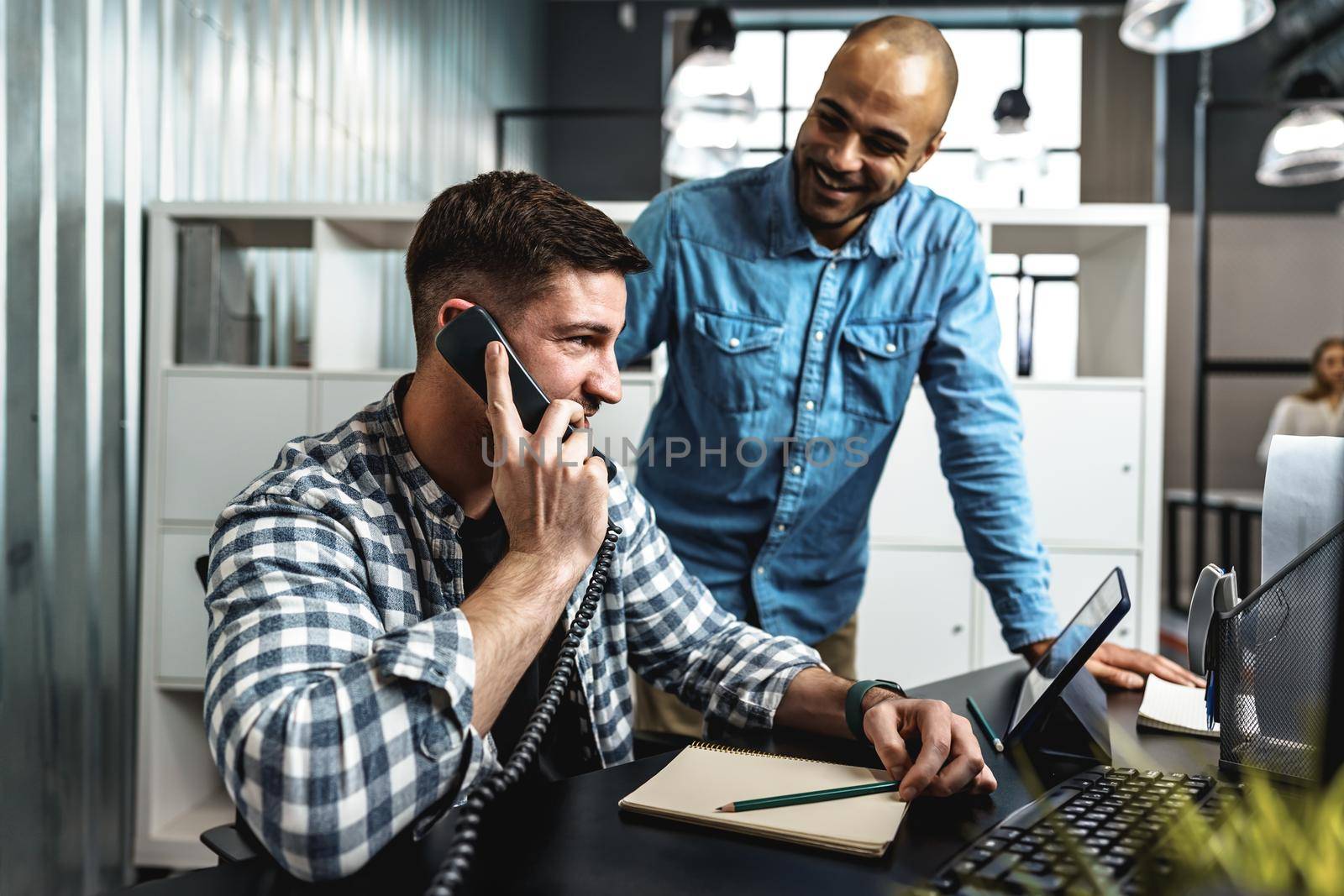 Two young men working together on a new business project in office, close up