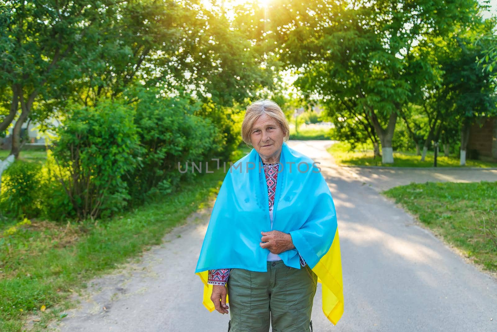 Grandmother in Ukrainian embroidered clothes. Selective focus. by yanadjana