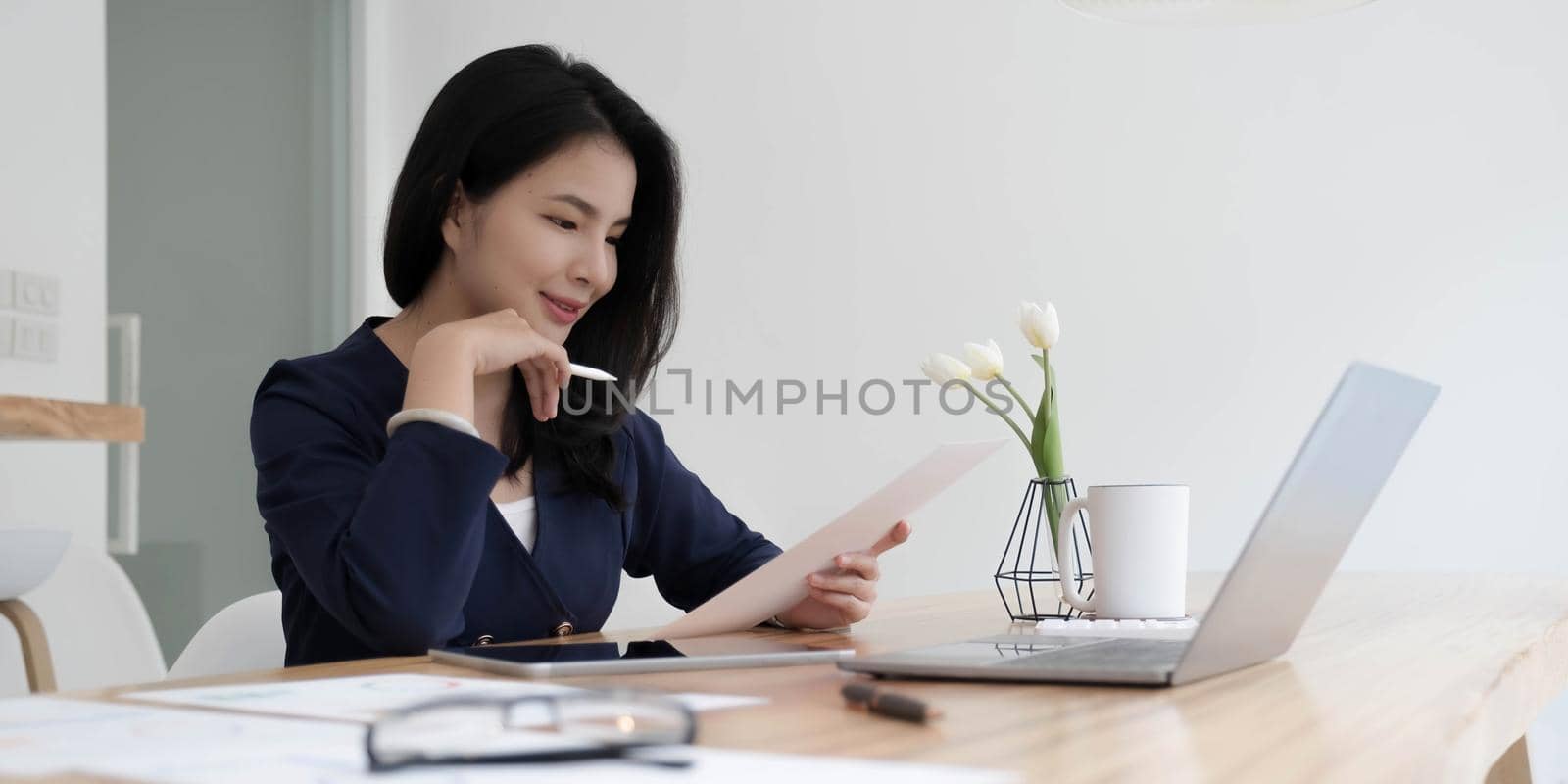 Asian businesswoman working in the office with working documents..