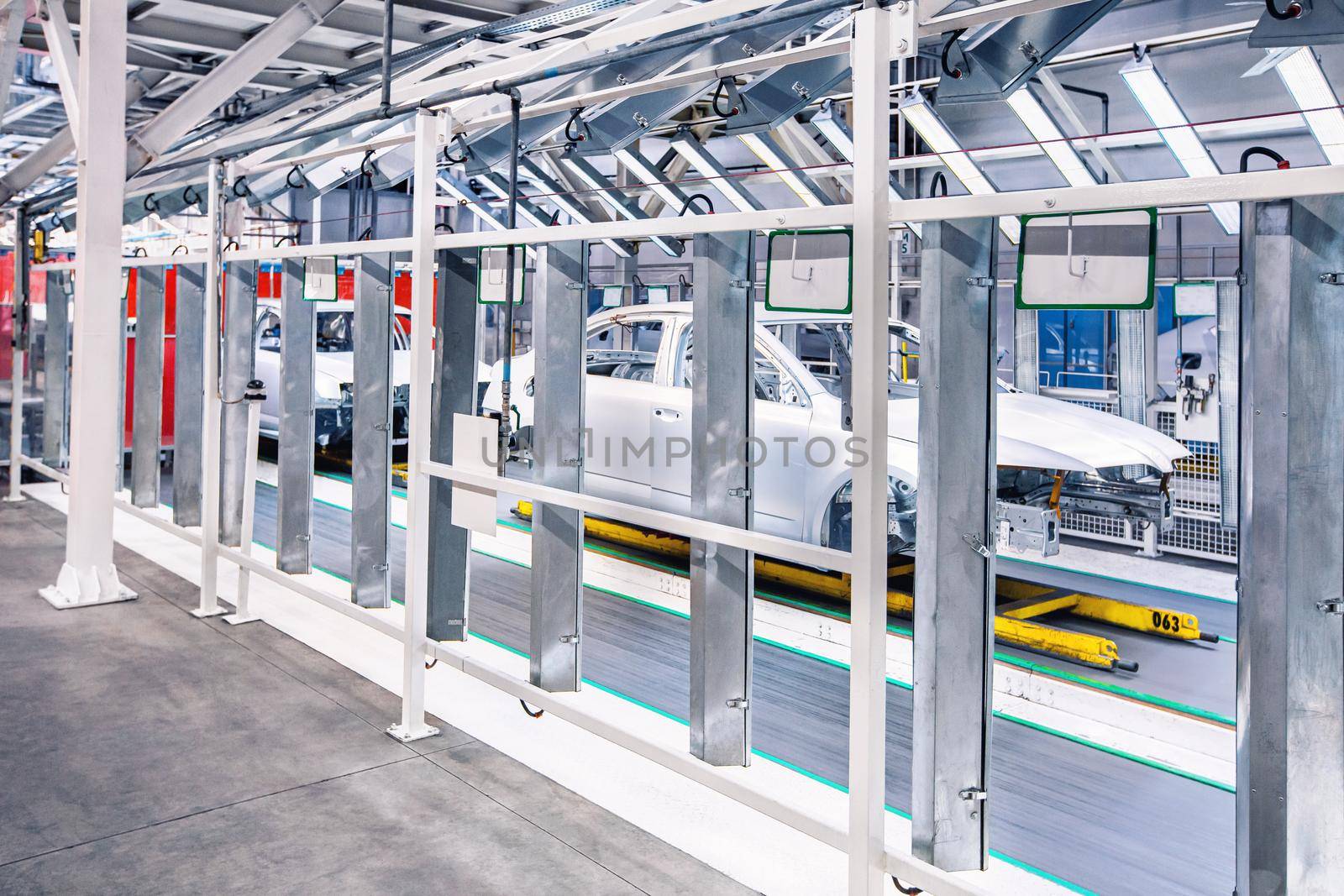 prepared cars in a row in control tunnel at car plant