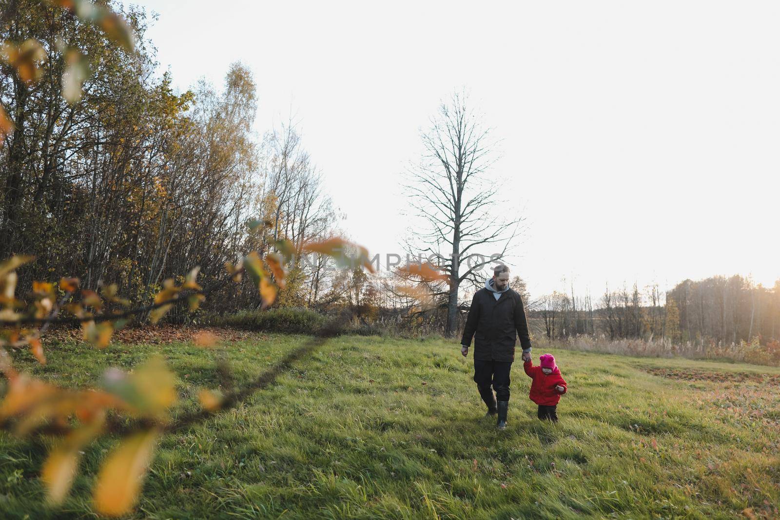 Happy father and child spending time outdoors. father with daughter in autumn park.