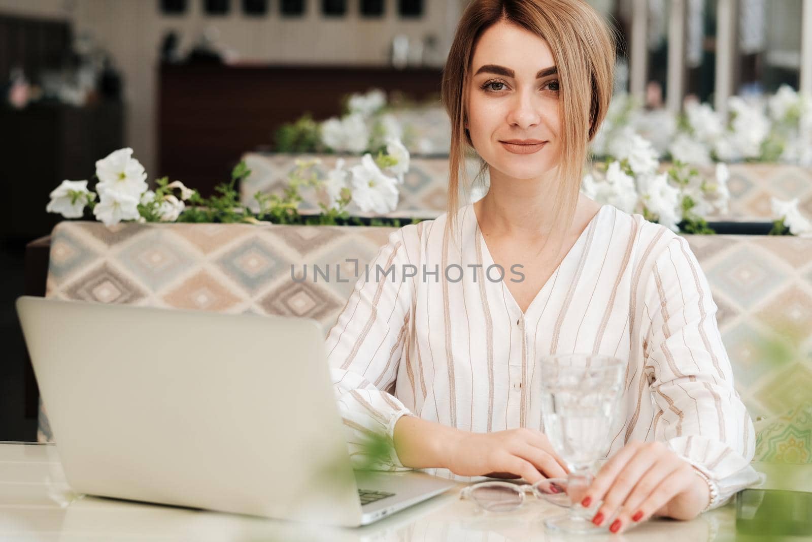 Confident Young Woman Looking Straight Into Camera, Female Working on Laptop While Having Lunch in Restaurant