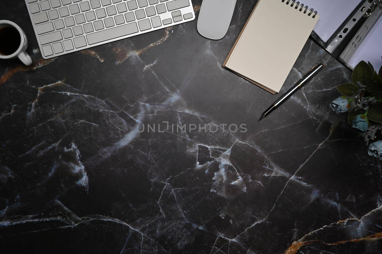 Top view empty notepad, wireless keyboard and mouse on marble background. by prathanchorruangsak