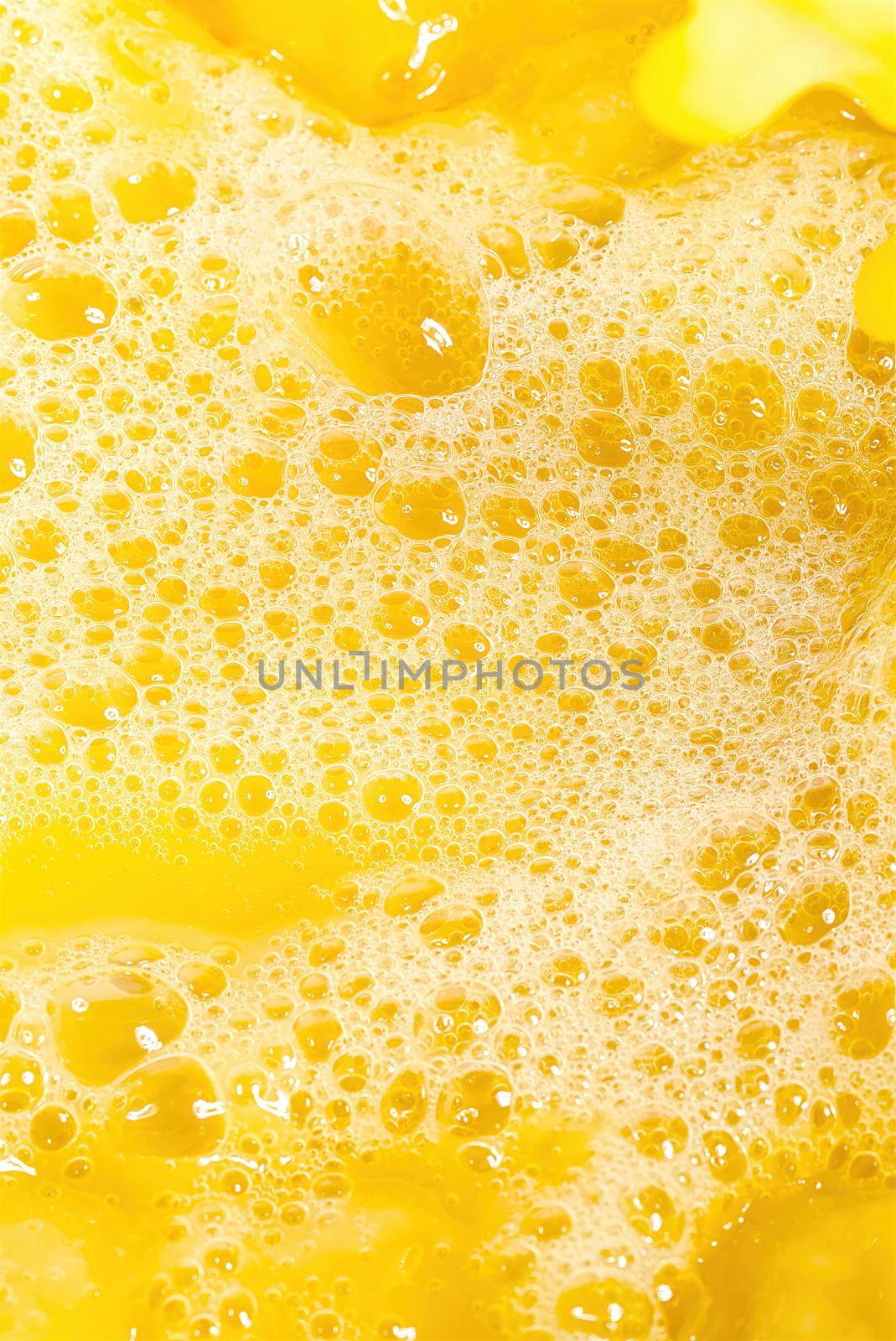 Closeup of splashing orange juice, top view. Splash of fresh sweet orange, mango, fruit juice. by PhotoTime