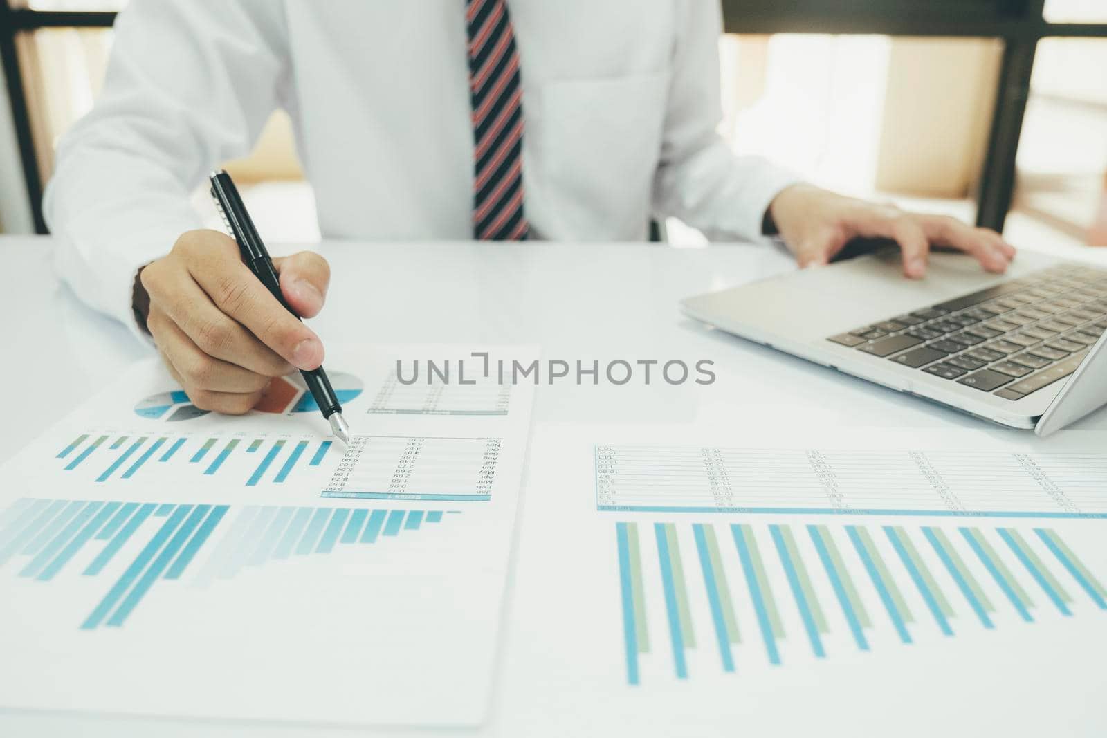 Businessman is thinking and analysis planning the strategy analysis, charts and graphs in meetings and successful teamwork ideas.