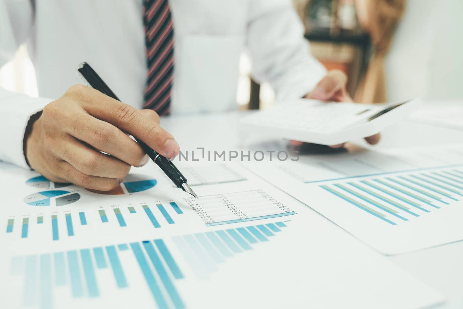 Businessman is thinking and analysis planning the strategy analysis, charts and graphs in meetings and successful teamwork ideas.