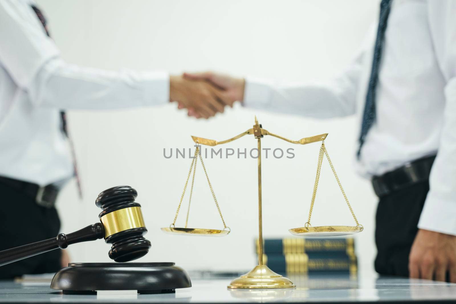 Judge and Businessman shaking hands after behind-the-scenes advice at attorney services concept courtroom. by ijeab