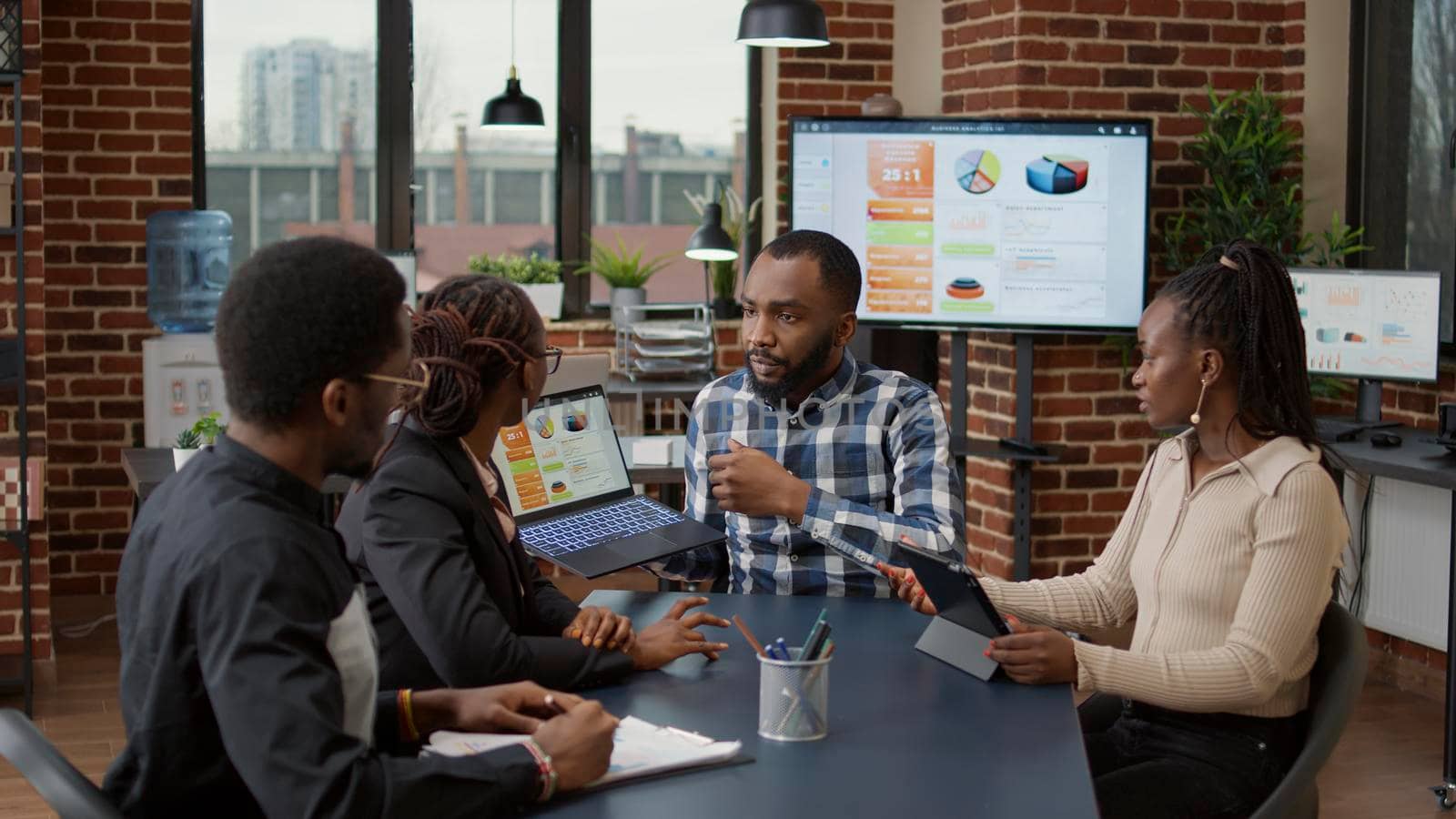 Team of african american people meeting in office to plan business strategy by DCStudio