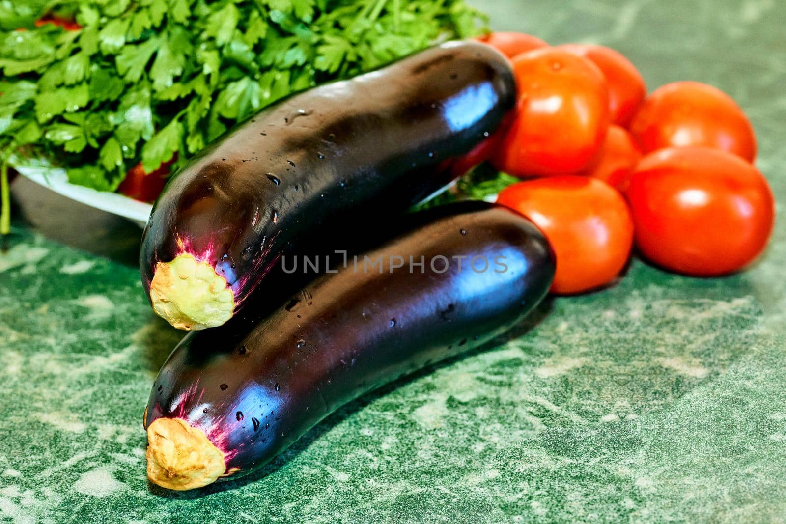 a plant or part of a plant used as food, typically as accompaniment to meat or fish, such as a cabbage, potato, carrot, or bean. Cooking delicious and healthy food.Eggplants, tomatoes and parsley.