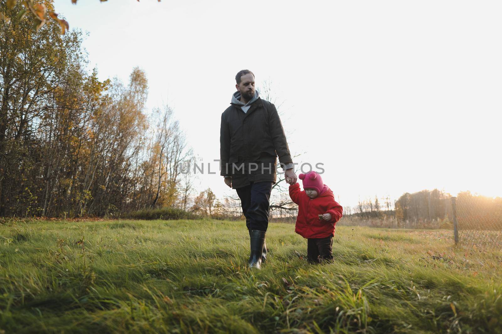 Happy father and child spending time outdoors. father with daughter in autumn park.