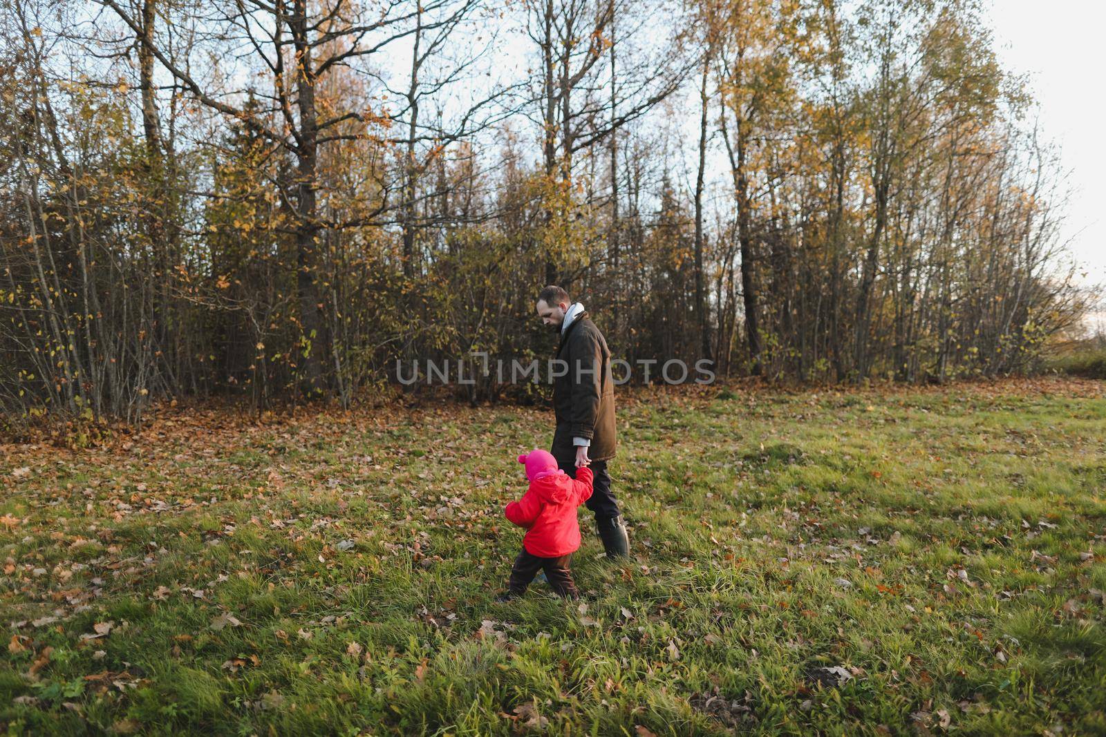 Happy father and child spending time outdoors. father with daughter in autumn park.