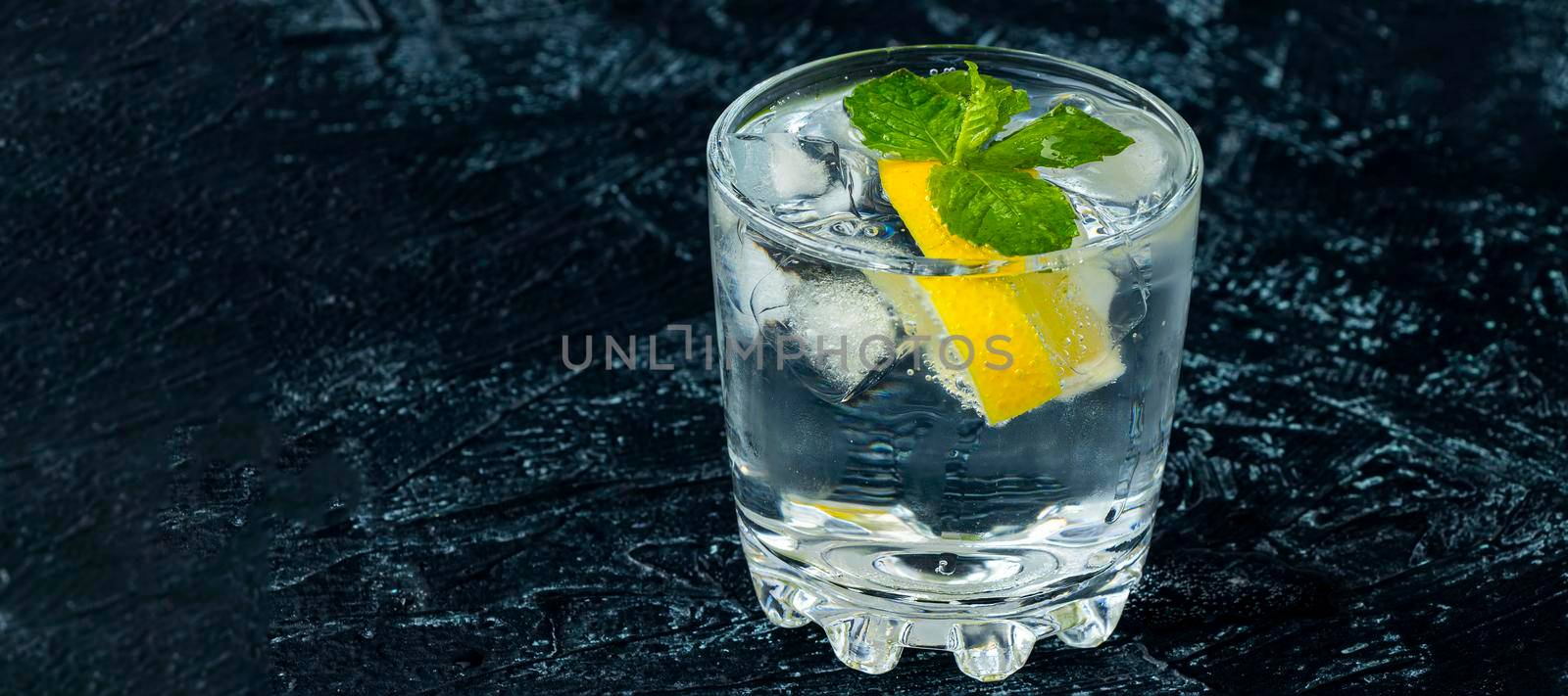 banner with serving mojito in glass. drink with lemon, mint, soda and ice on a black and white background. by Leoschka