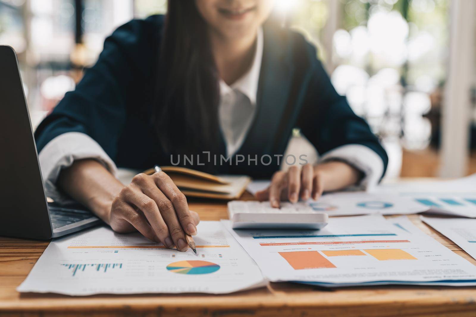 Close up business accounting concept, Business asian woman using calculator with computer laptop, budget and loan paper in office