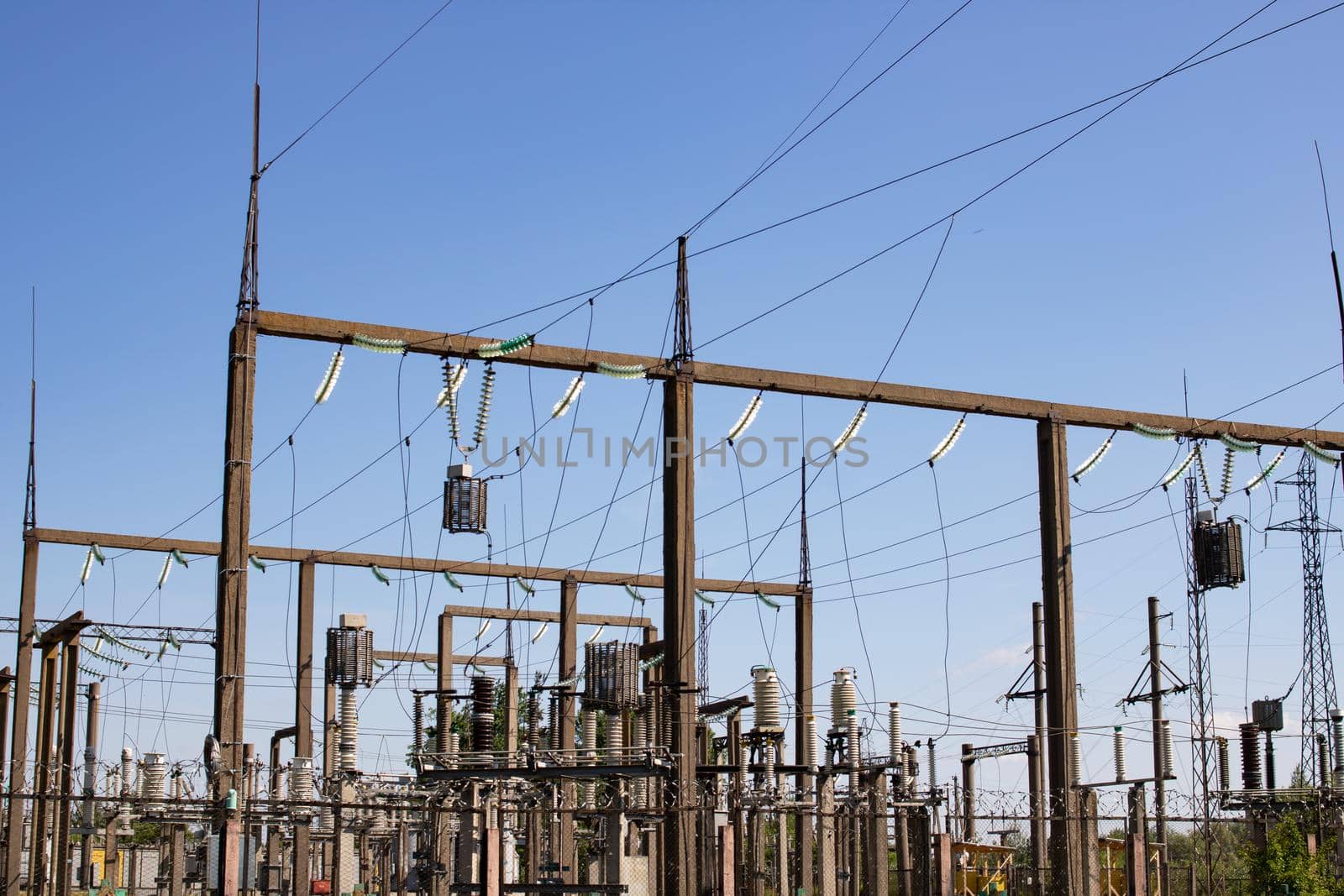 Pillars with power lines on a blue sky background