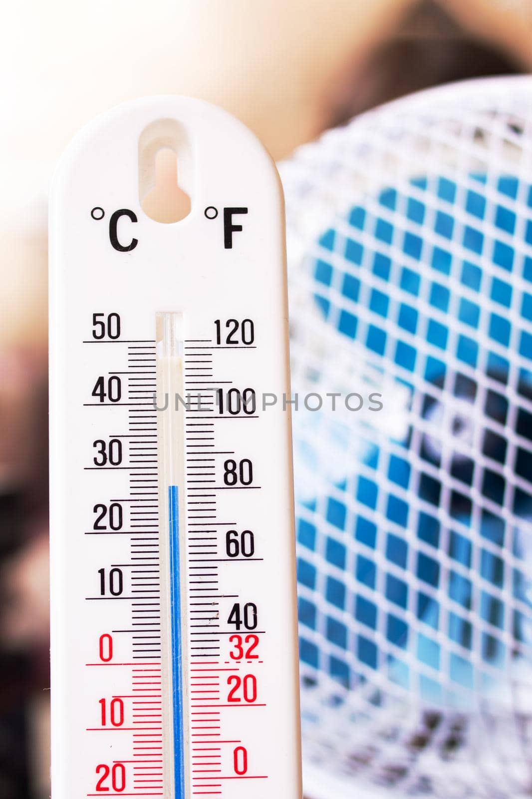 Small fan and room mercury thermometer close up