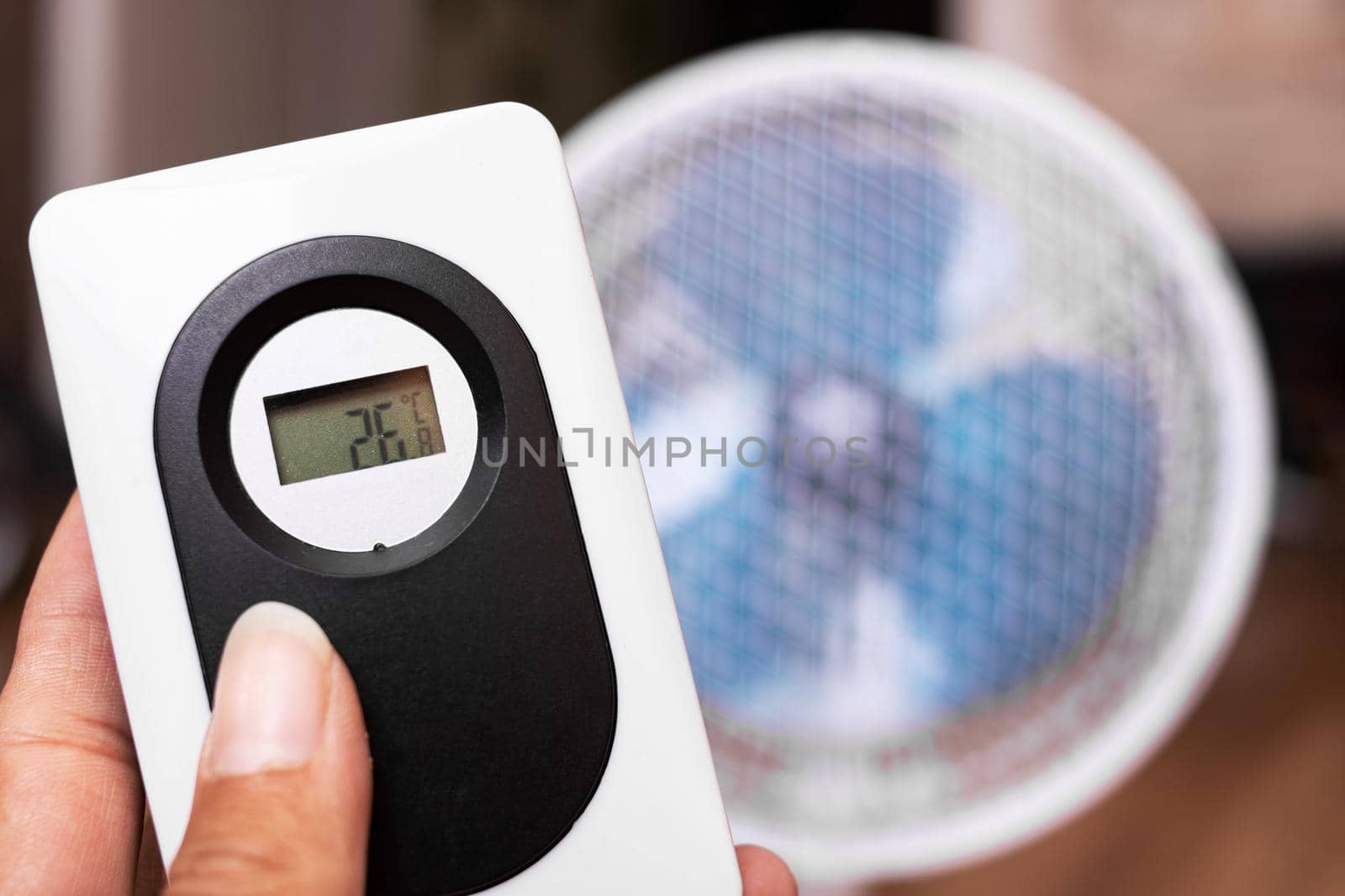 Small fan and room electronic thermometer close up