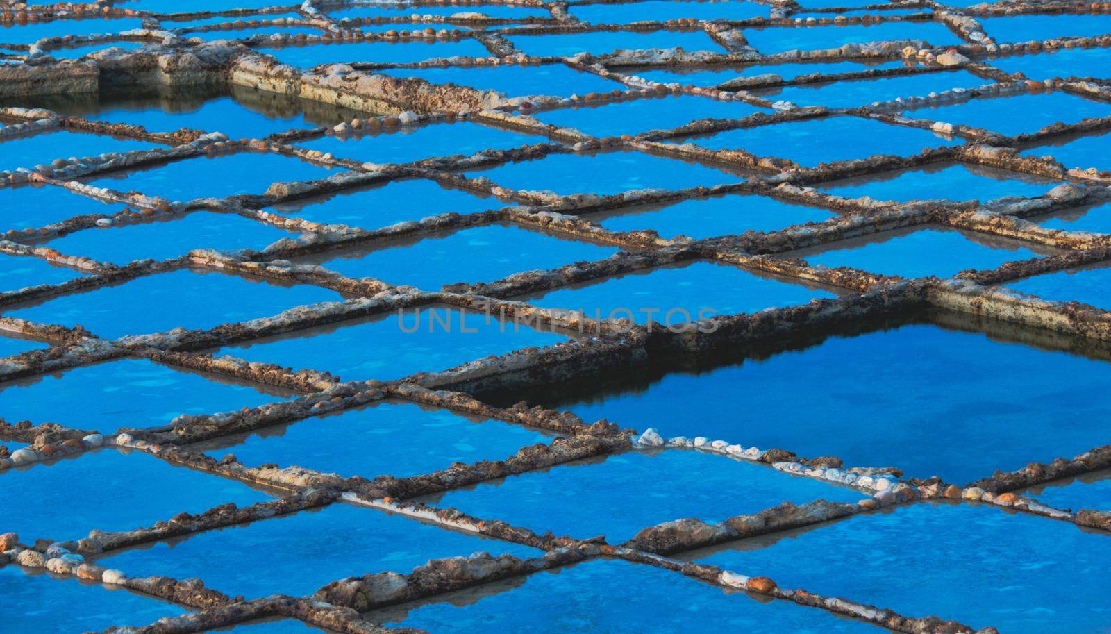 Rows of natural salt pans cut into the rock on the coast