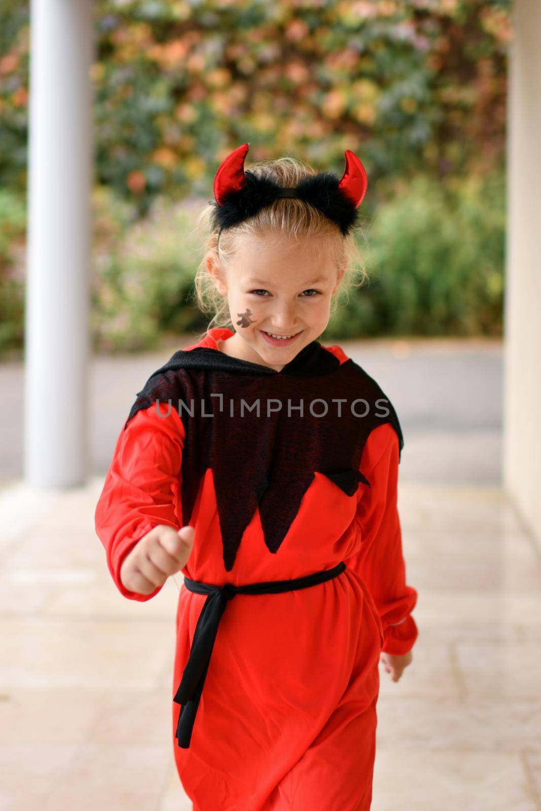 Scary girl dressed as a devil with horns