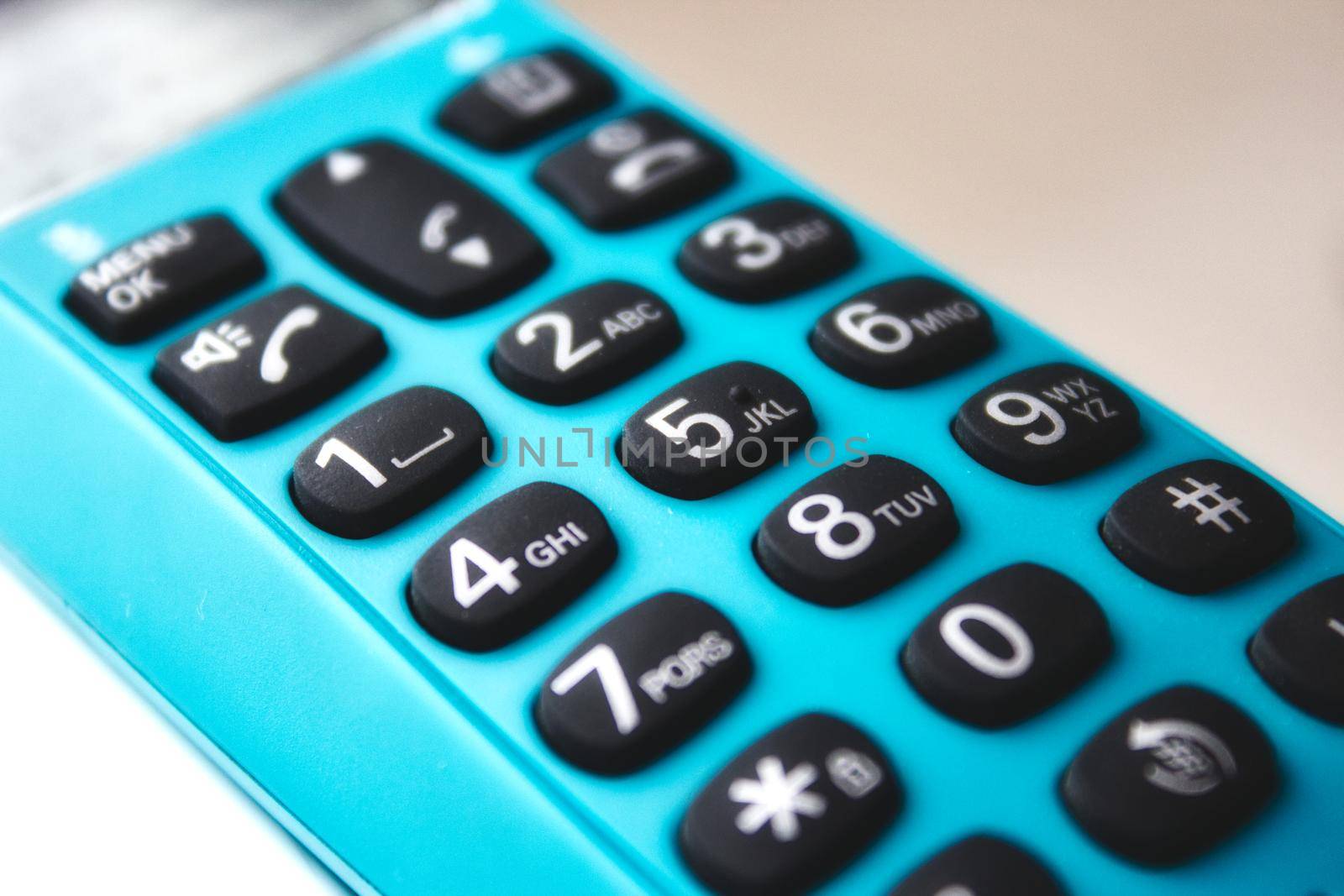 Closeup on keypad of a blue hand-held phone by tennesseewitney