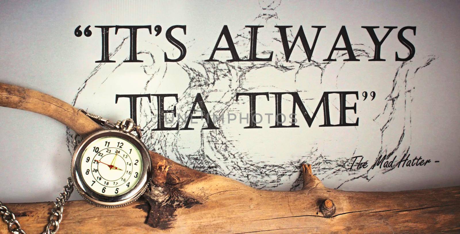 It´s always time for tea - silver pocket watch with chain on a tree branch quoting the Mad Hatter from Alice in Wonderland